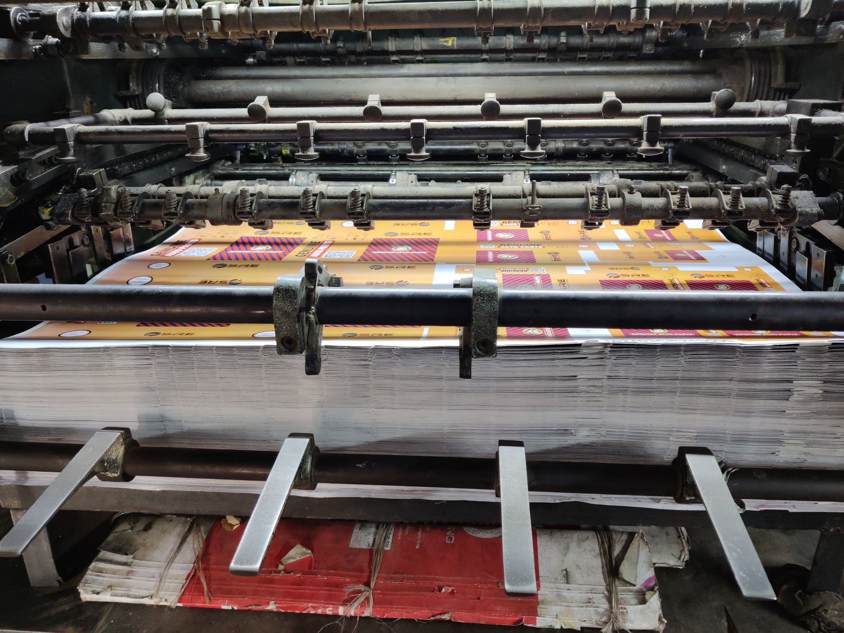 Printed sheets running through an offset printing press