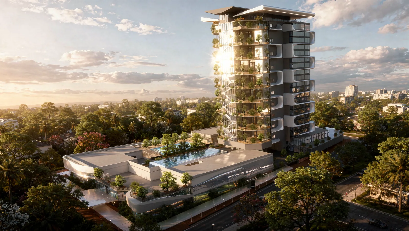 Aerial view of the tower and podium roof with a residents’ pool and gardens, over the trees of Kuala Lumpur